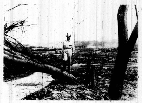 American physicist Robert Serber at Nagasaki, September 1945, showing a tree snapped by the blast 4,000 feet from Ground Zero.