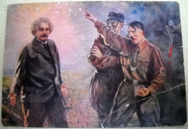 Usual, rare anti-Nazi propaganda postcard from 1934, showing Hitler expelling Einstein from Germany, titled "The Ignominy of the 20th Century." It is one of the most blatant visual renderings of Einstein as a "scientific saint." Source.