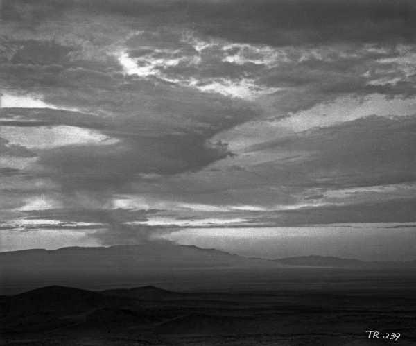 The late stages of the Trinity cloud as viewed from many miles distant, as it becomes a shifting, twisting column of radioactive dust. Obtained from Los Alamos National Laboratory.