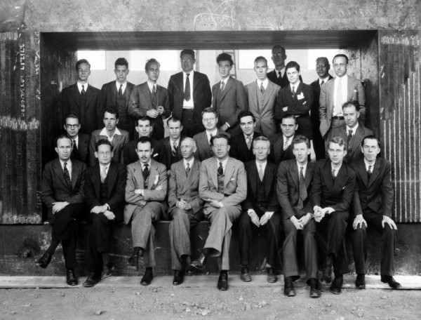 The scientific staff of the University of California Radiation Laboratory with magnet of unfinished 60-inch cyclotron. Lawrence is front and center. Oppenheimer stands in back. Credit: Emilio Segrè Visual Archives.